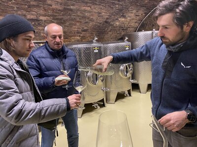 Martin Bergkirchner schenkt Lorenz und Peter eine Fassprobe des GV Smaragd Poigen ins Glas